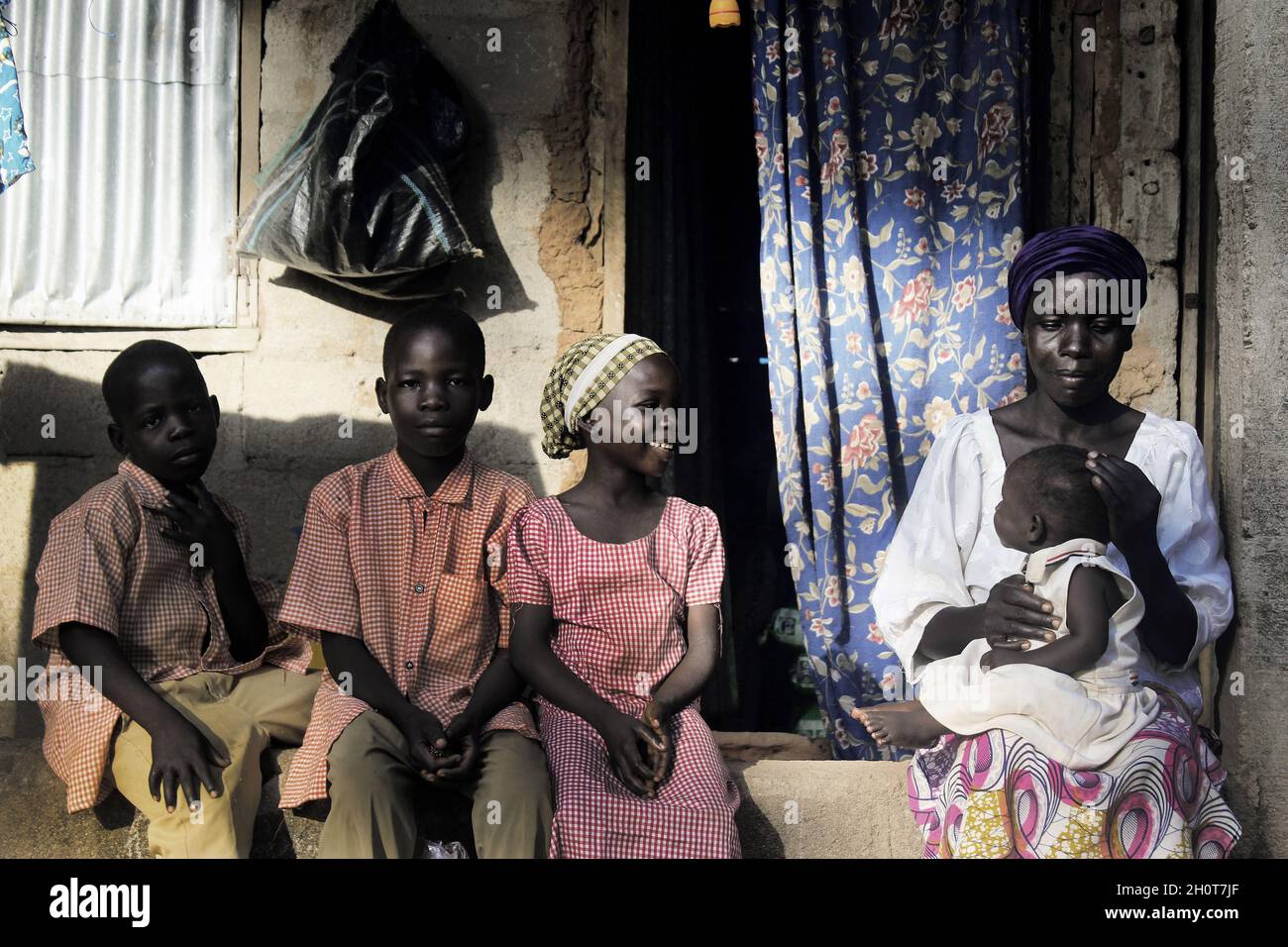 Members of Boko Haram chased Martha Garba out of Gulak, Madagali, in Adamawa State, after an attack in which Martha’s husband was murdered. Contrary to Martha’s story, her neighbours claim that members of Boko Haram captured and threatened her to deceptively convince her husband to descend a mountain, which served as her family’s fortress. Allegedly deceived by his wife, whom was under Boko Haram’s threat, Martha’s husband thought his village was freed of Boko Haram, and so returned to his death, at his house. Martha eventually escaped with her five children to Yola, the state capital of Adama Stock Photo