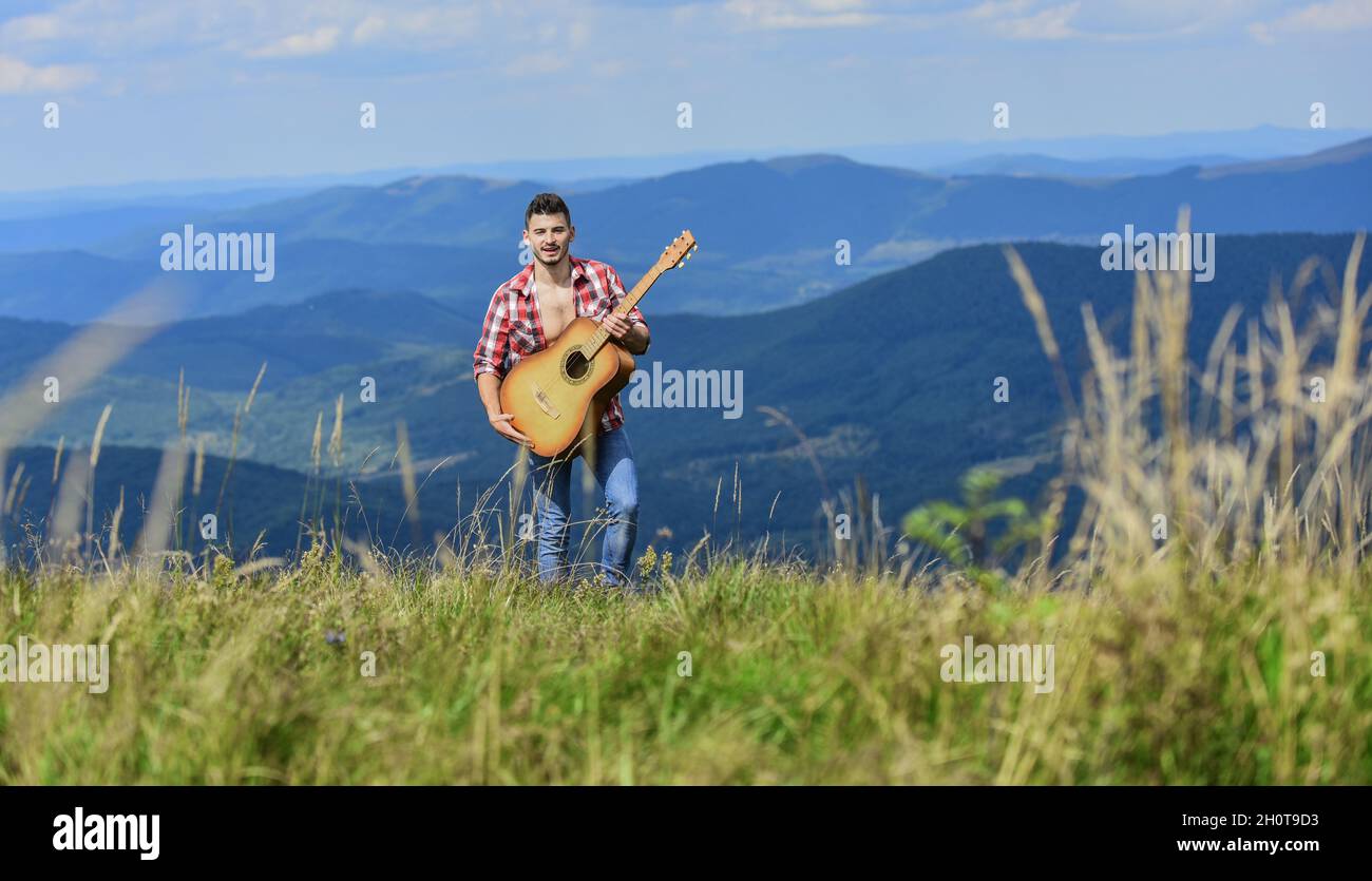 Peaceful hiker. Conquer the peaks. Man hiker with guitar walking on top ...