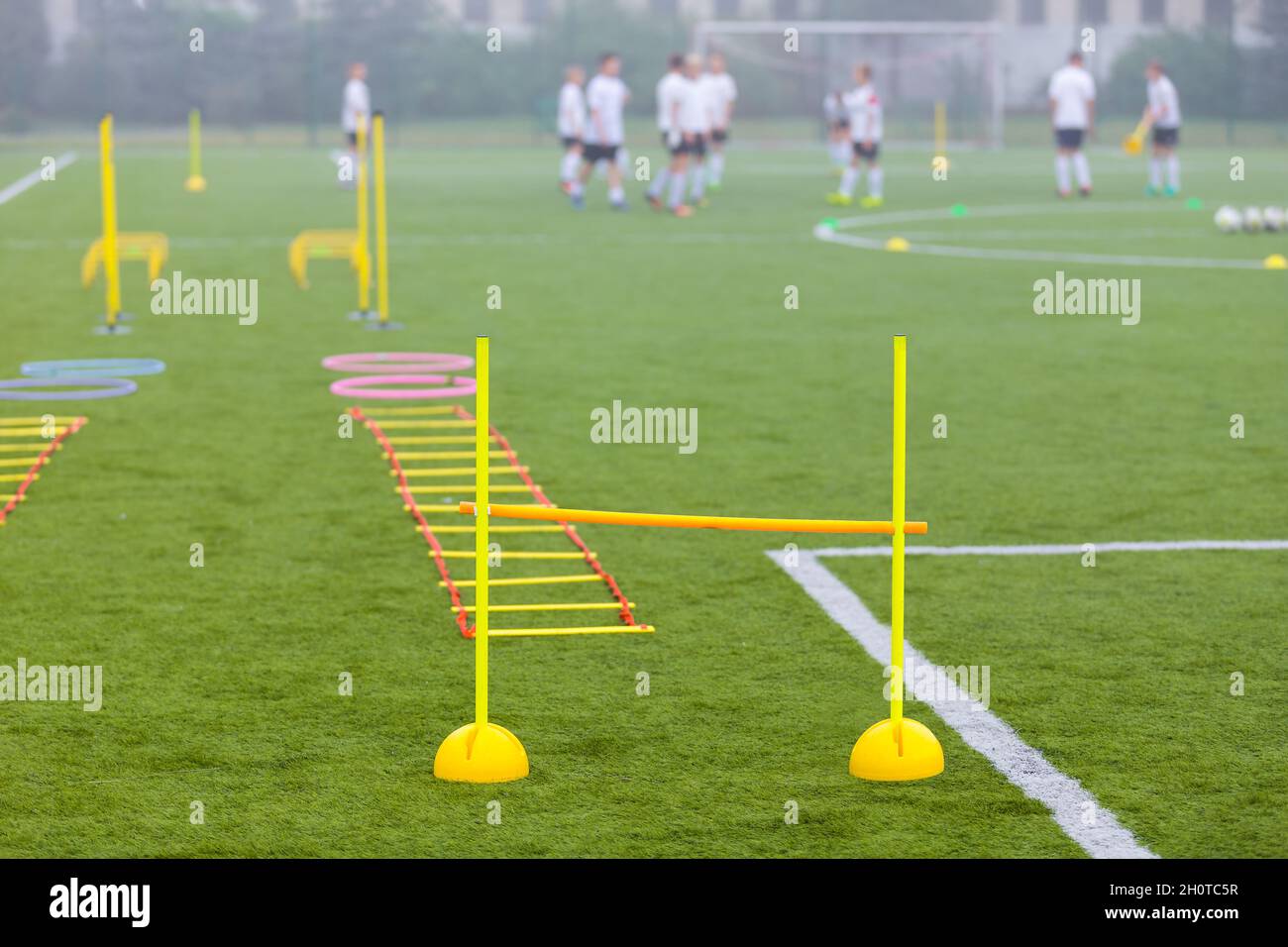 Sports Football Training Field. Soccer Equipment For Practice Drills. Players in a Team Ready to Start Training Session Stock Photo