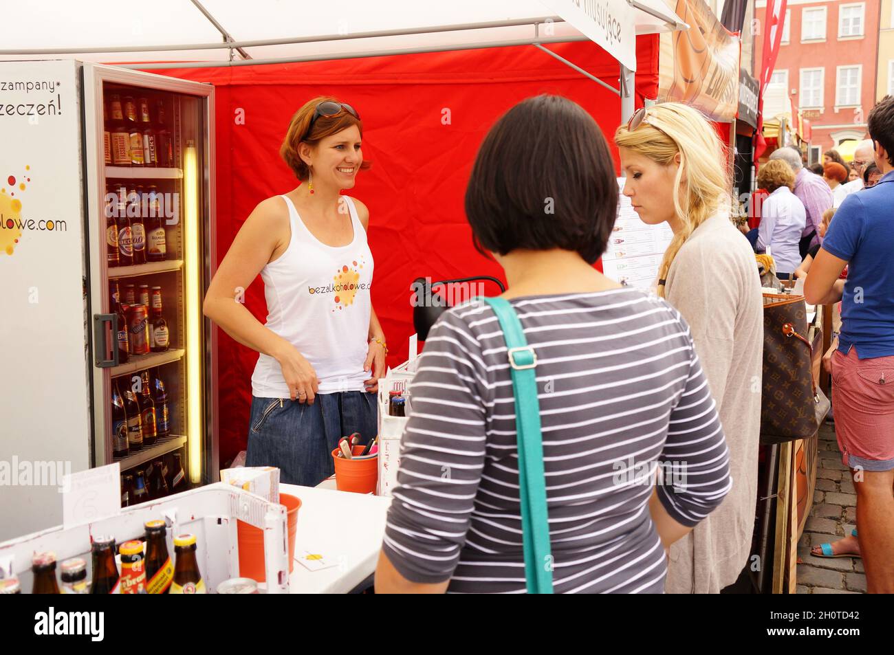 POZNAN, POLAND - Aug 15, 2013: A pregnant woman buying alcohol free beer during a food festival in the old city square Stock Photo