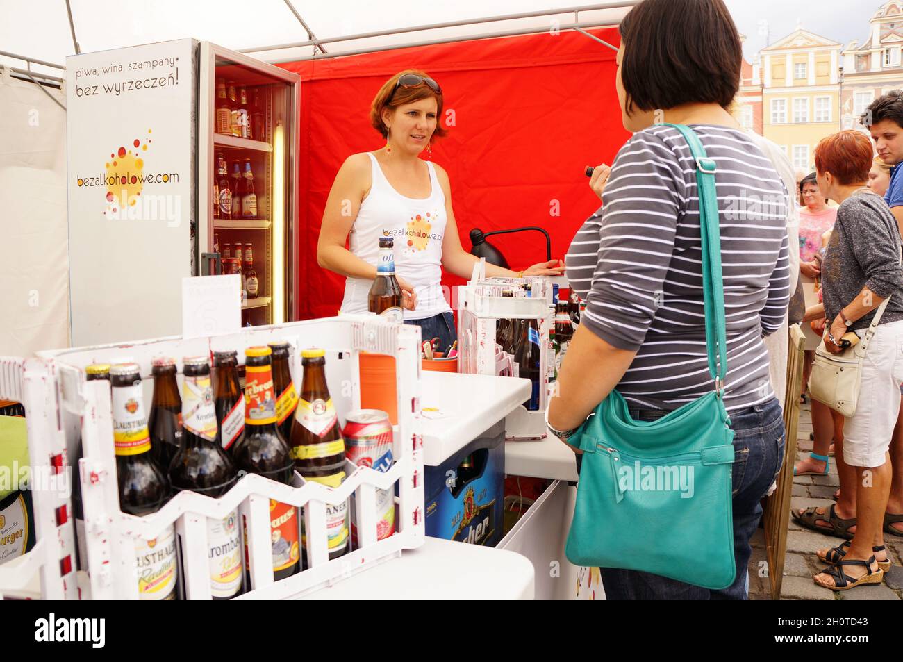 POZNAN, POLAND - Aug 15, 2013: A pregnant woman buying alcohol free beer during a food festival in the old city square Stock Photo