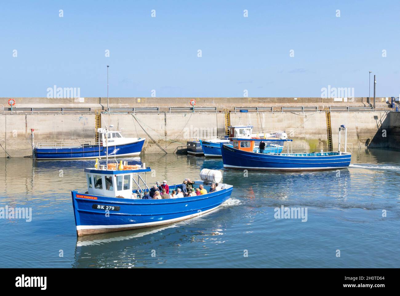 Fishing boats and sightseeing trips to the Farne Islands Seahouses Harbour North Sunderland Harbour Northumberland coast Seahouses England GB UK Stock Photo