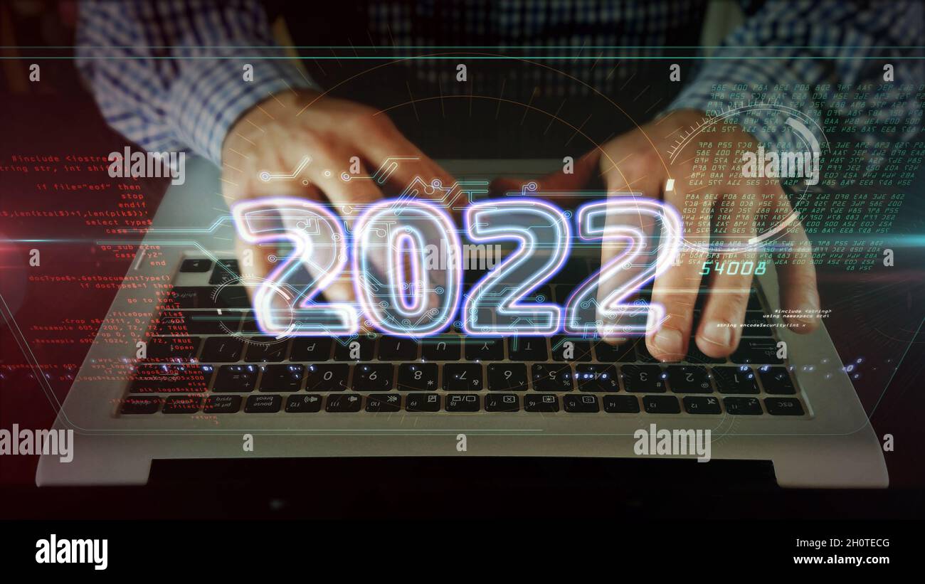 2022 year, new cyber design concept. Man typing on the computer keyboard. Futuristic light symbol abstract. Stock Photo