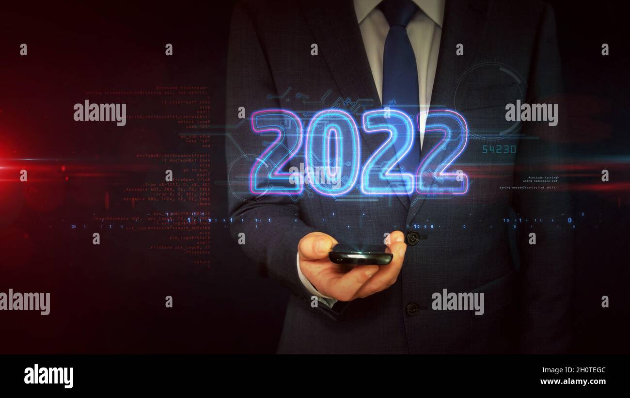 2022 year, new cyber design concept. Businessman touch the hologram display in hand. Futuristic light symbol abstract. Stock Photo