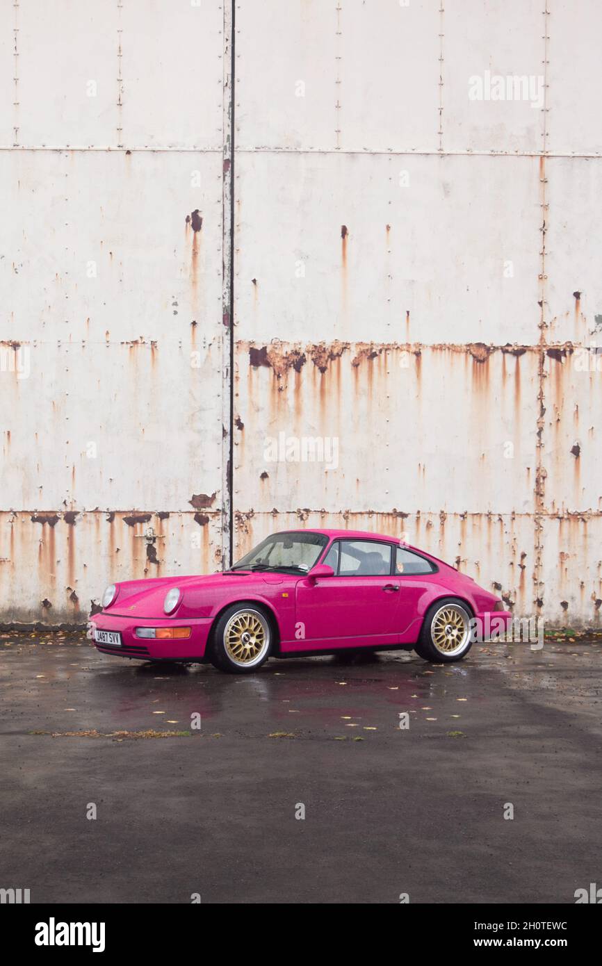 Pink Porsche 911 Carrera RS classic supercar attending a car gathering held  at Bicester Heritage, England Stock Photo - Alamy