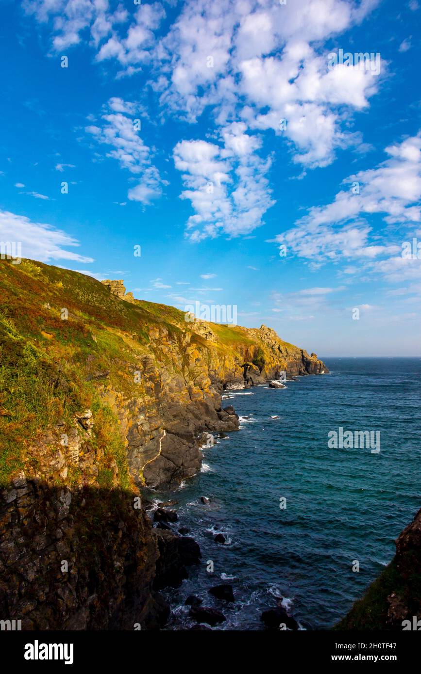 Rocky cliffs and coastline in summer at Housel Bay on the South West Coast Path near Lizard Point in south Cornwall England UK. Stock Photo