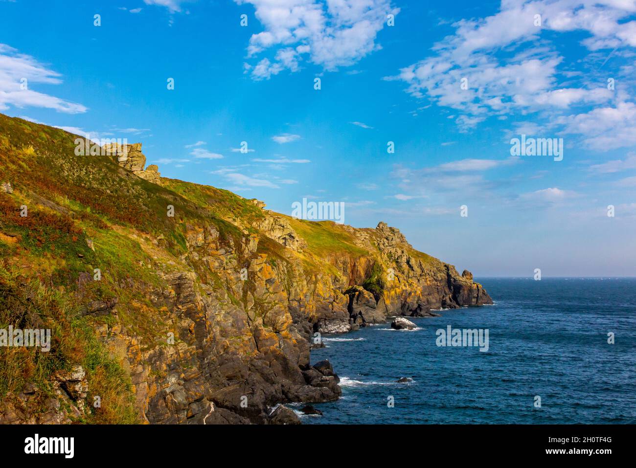 Rocky cliffs and coastline in summer at Housel Bay on the South West Coast Path near Lizard Point in south Cornwall England UK. Stock Photo