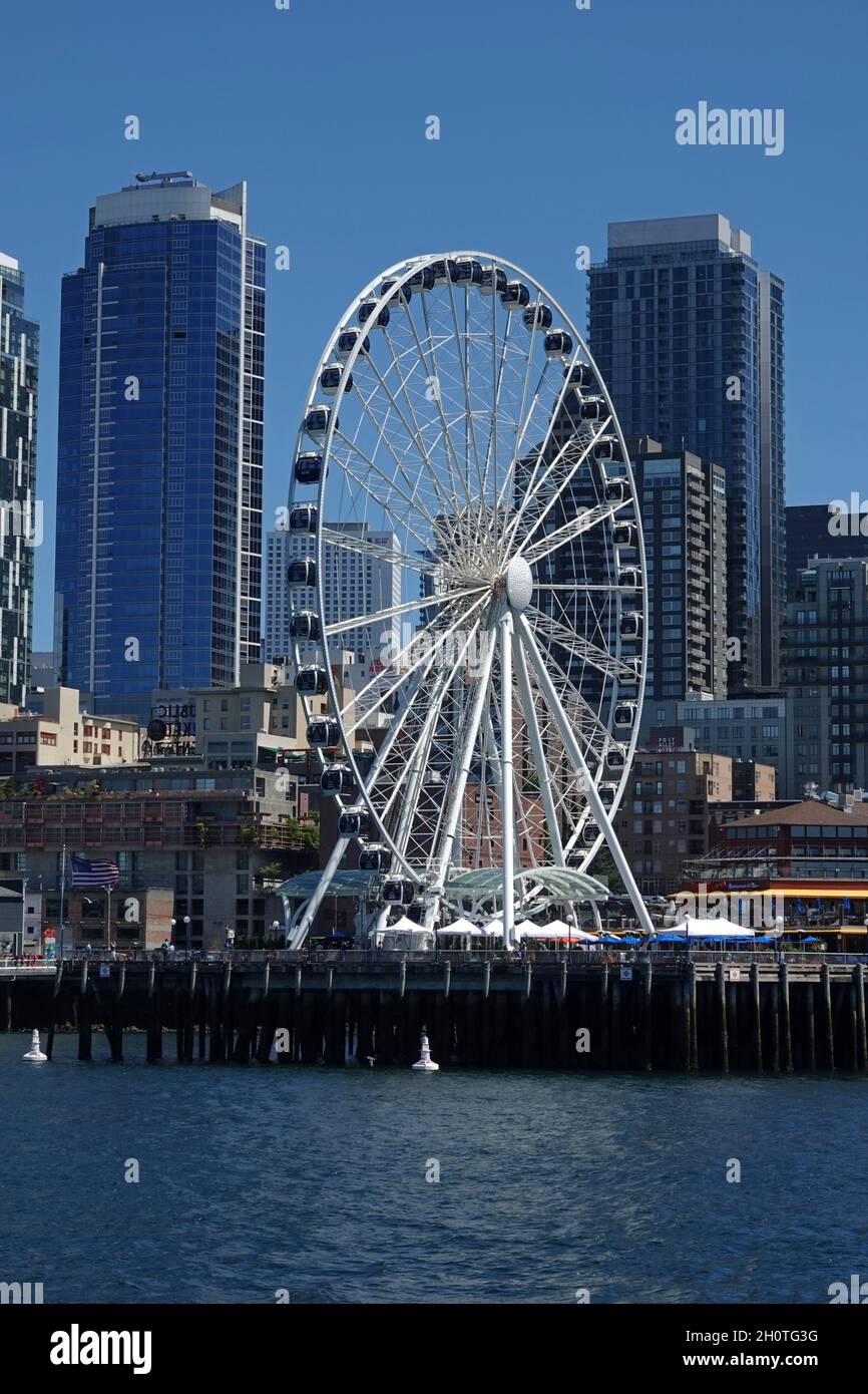 Seattle, WA / USA - June 25, 2021: The Seattle Great Wheel is shown in a vertical view during a summer day. The Ferris wheel is located at Pier 57. Stock Photo