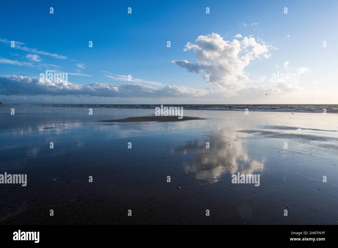 single big white cloud reflects in the ocean Stock Photo