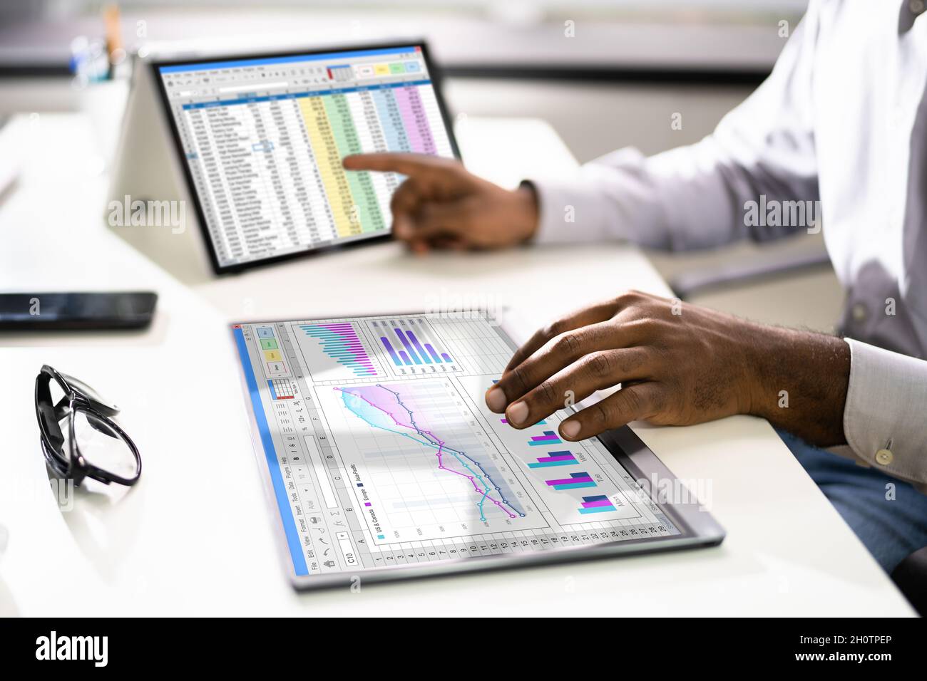 Electronic Spreadsheet Analyst Or Auditor Using Software On Hybrid Laptop Stock Photo