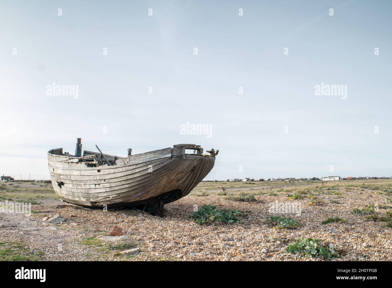 Abandoned and damaged wooden fishing boat wreck at the beach of ...