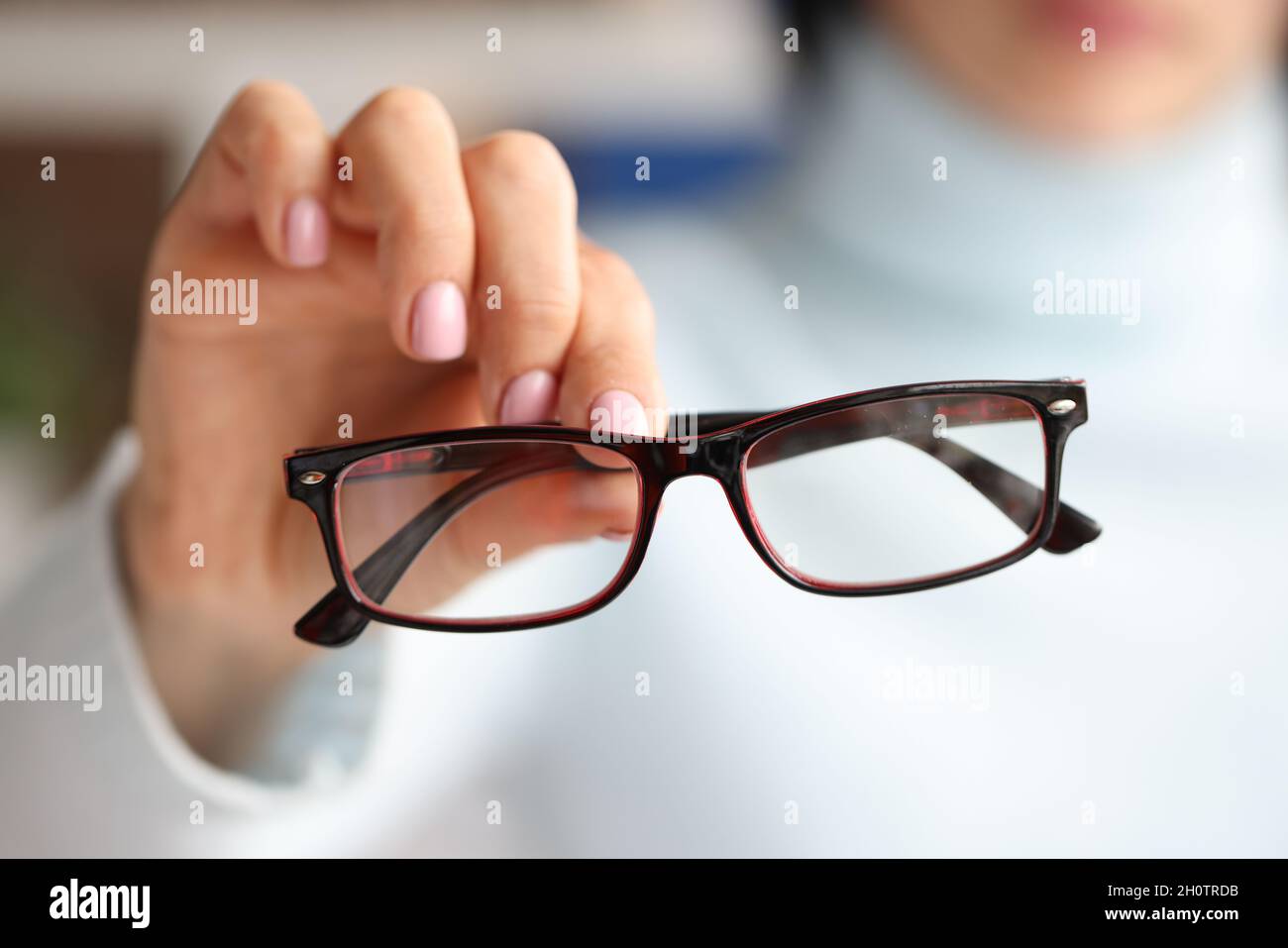 In female hand there are stylish fashionable glasses in black frames Stock Photo
