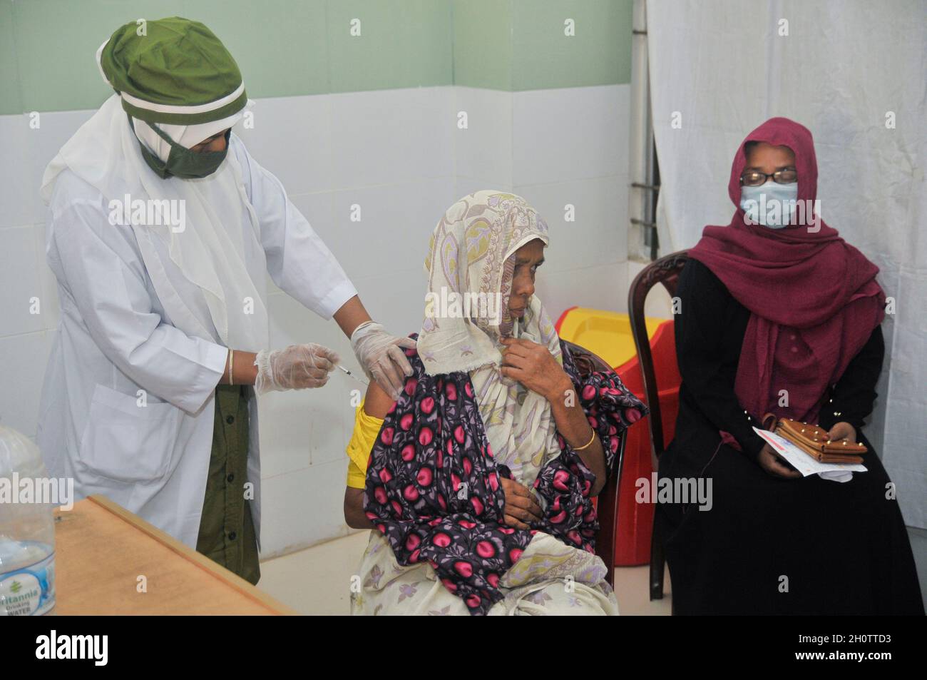 Sylhet, Bangladesh. 14th Oct, 2021. Medical staff administer the 1st dose of the Pfizer-BioNTech Covid-19 Vaccine at the M A G Osmani medical college & hospital vaccination center. Credit: Majority World CIC/Alamy Live News Stock Photo