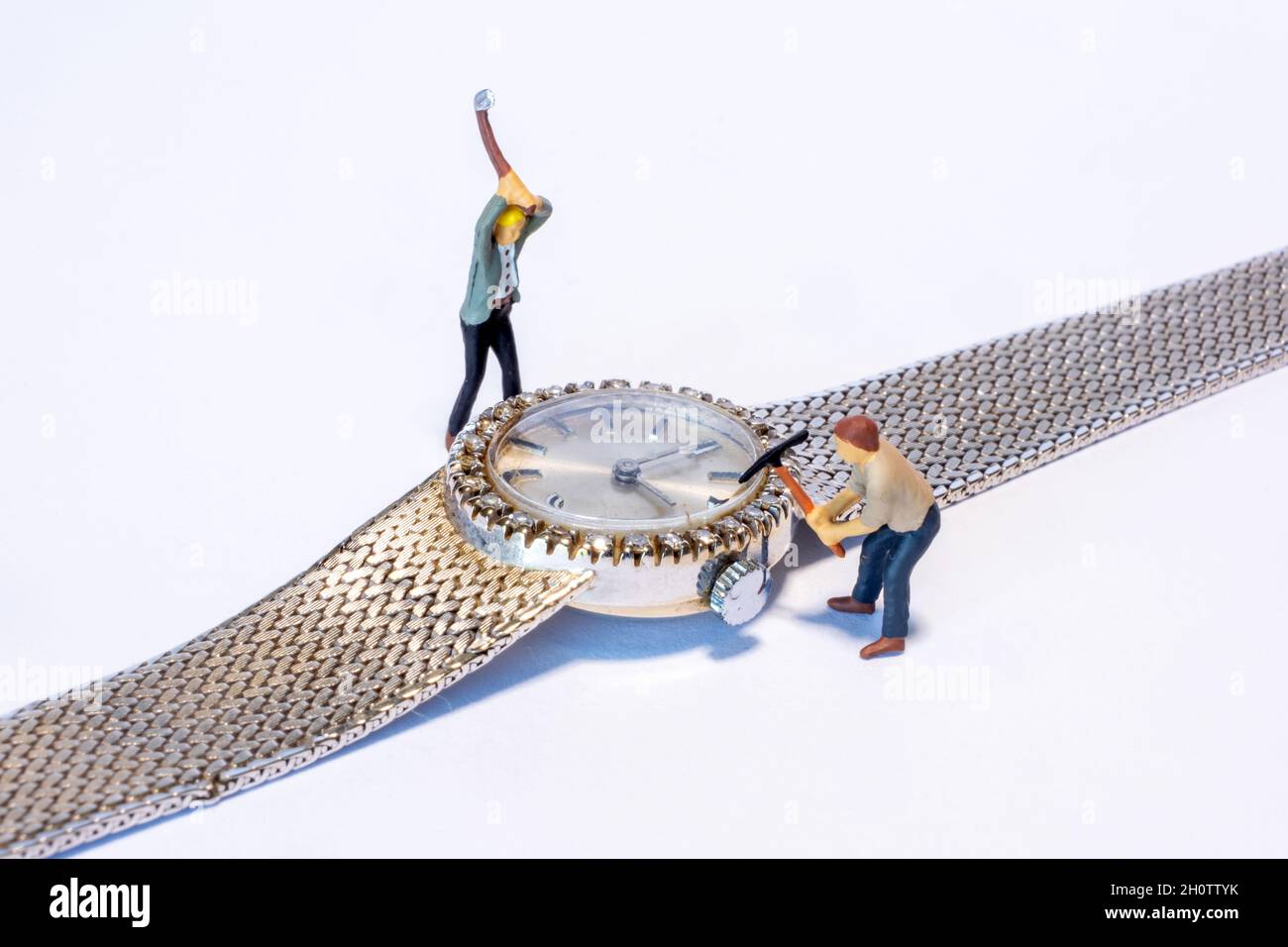 closeup of miniature people working on a diamond watch Stock Photo