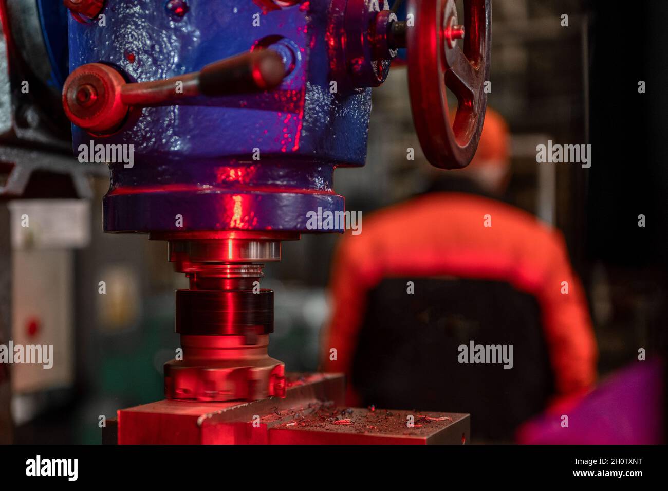 An old-fashioned vertical milling machine cuts a metal part Stock Photo