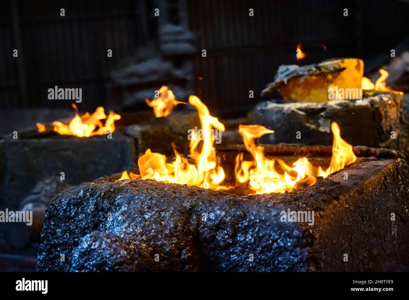 Steel molds for metal pouring. A fire burns at the top of the molds Stock Photo
