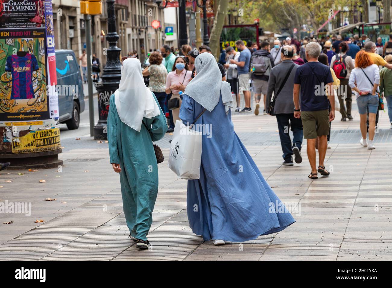 Barcelona, Spain - September 19, 2021: Muslim women wearing  traditional Islamic clothing, are going for shopping Stock Photo
