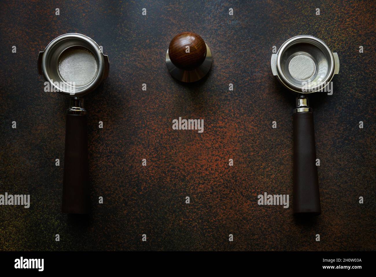 Two empty holders with baskets for single and double espresso and