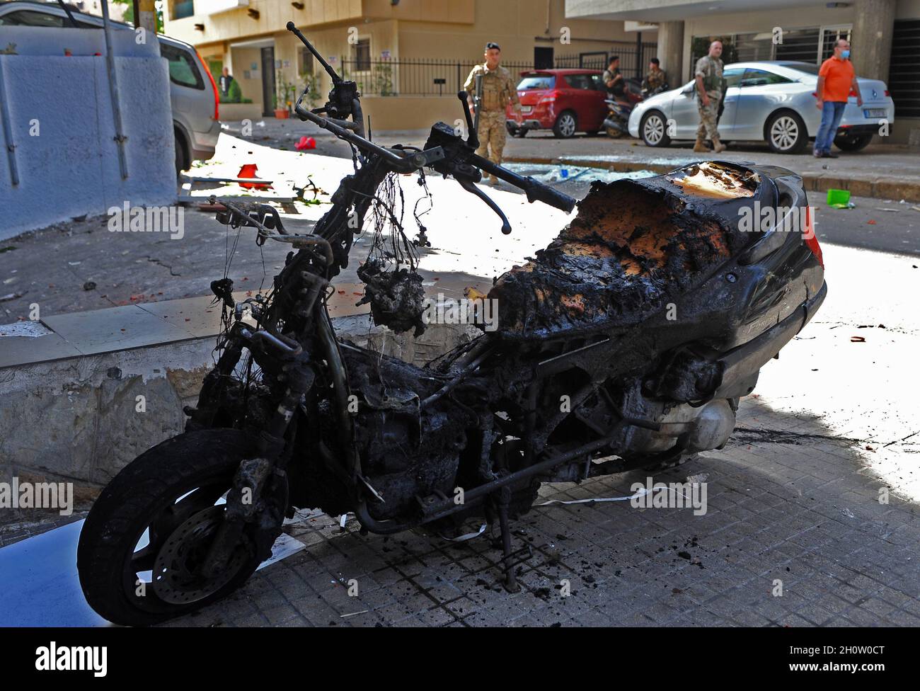 Beirut, Lebanon. 14th Oct, 2021. A damaged motorcycle is pictured as soldiers are deployed after gunfire erupted in Beirut, Lebanon, on Thursday on October 14, 2021. Armed clashes broke out in Beirut Thursday during the protest against the lead judge investigating last year's massive blast in the city's port, as tensions over the domestic probe boiled over. photo by Jamal Eddine/ Credit: UPI/Alamy Live News Stock Photo