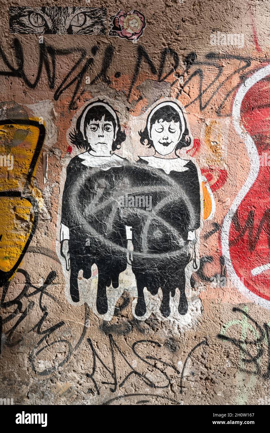 Street art. Cut-to-shape paste-up poster on wall in Trastevere district of Rome, Italy. Stock Photo