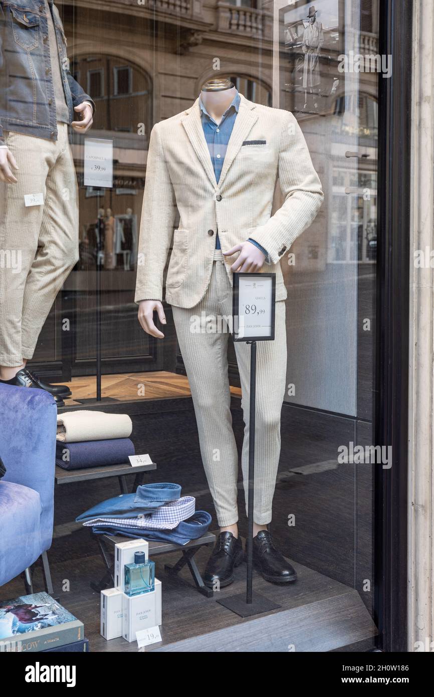 Off-white corduroy suite in clothing store display window in Rome, Italy Stock Photo