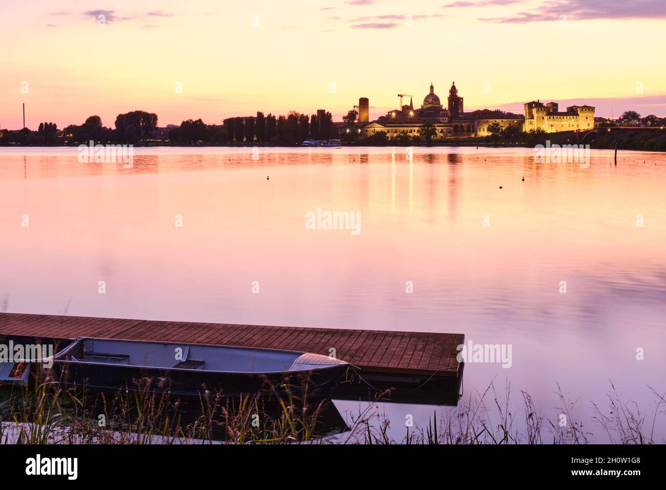 Medieval castle and city skyline illuminated at sunset, Mantua, Italy
