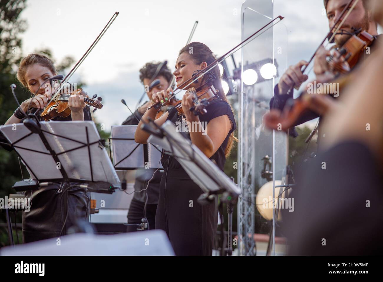 Violin players giving concert on the street Stock Photo