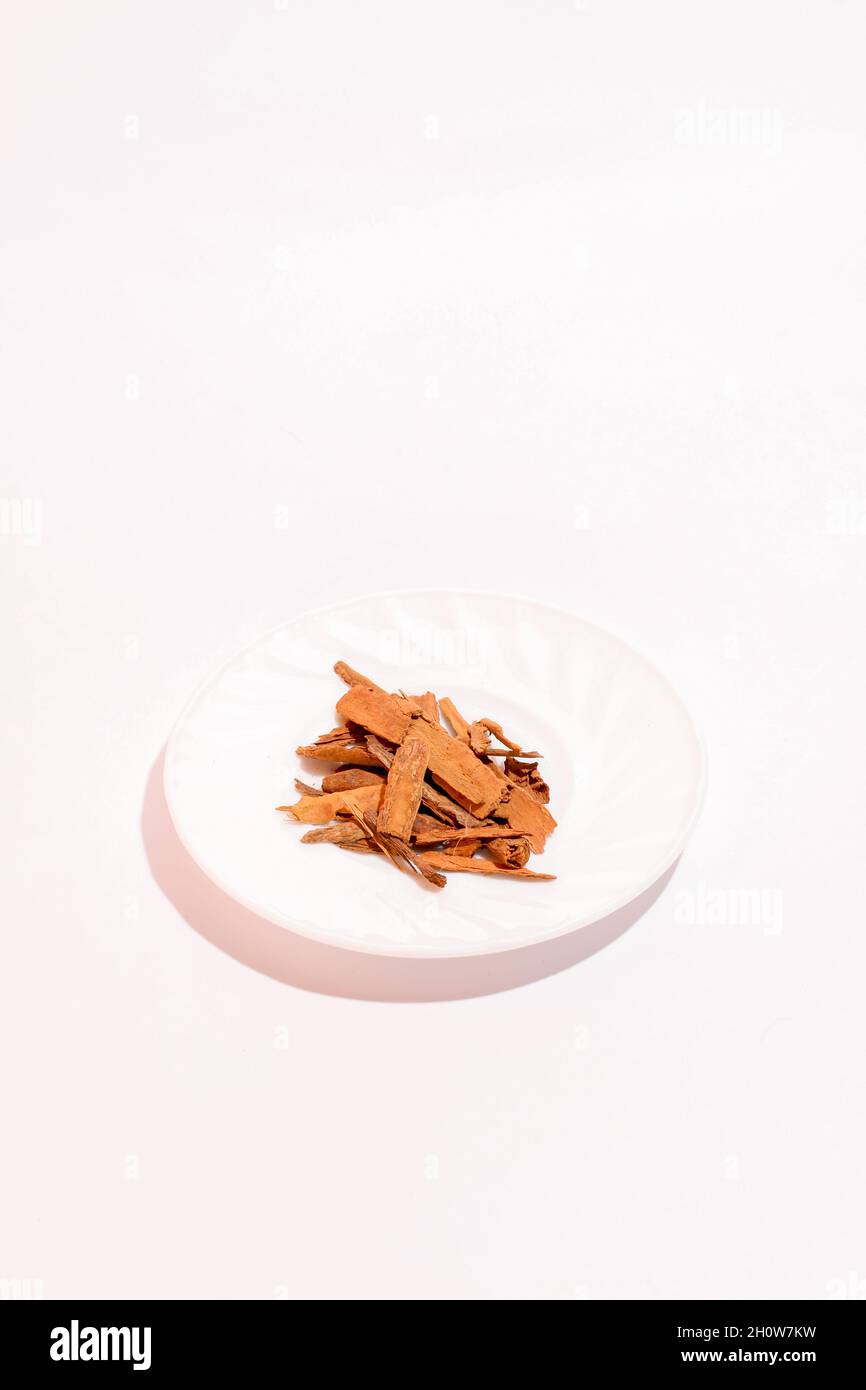 Split cinnamon for cooking stacked on white background. Pile of