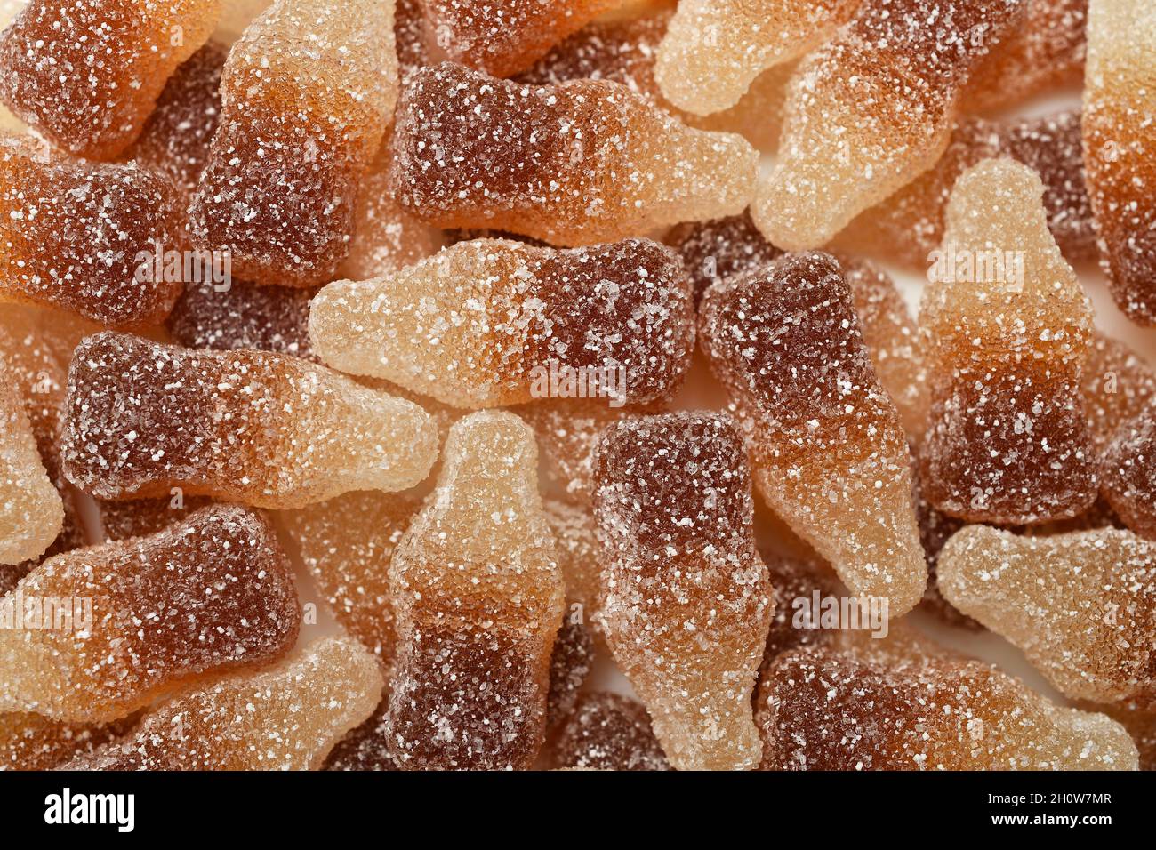 Cola-flavored chewable bottle-shaped gummy candies covered with sugar crystals Stock Photo