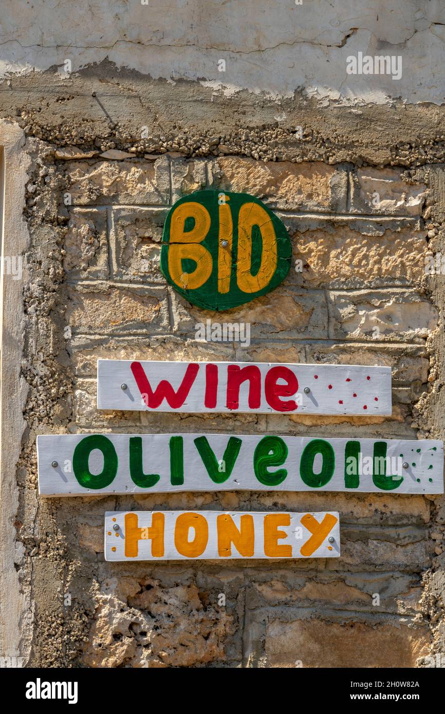 wine olive oil and honey signs on sale at a greek tourists shop on the isleand of zante or zakynthos greece. honey, wine, olive oil, sales, shopping. Stock Photo