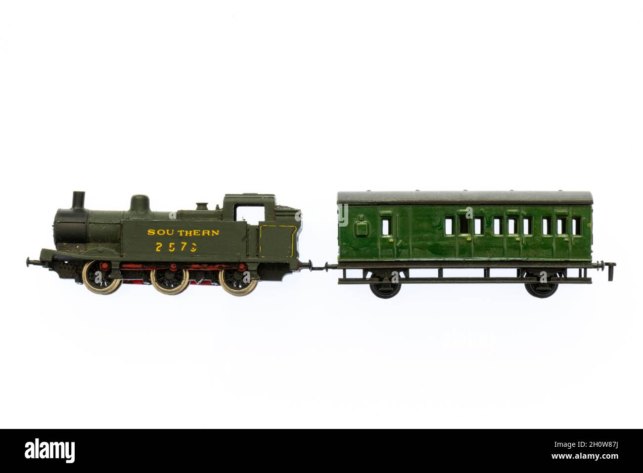 model railway toy train in green southern railway livery. model railways steam train and carriage against a plain white background. model train set. Stock Photo