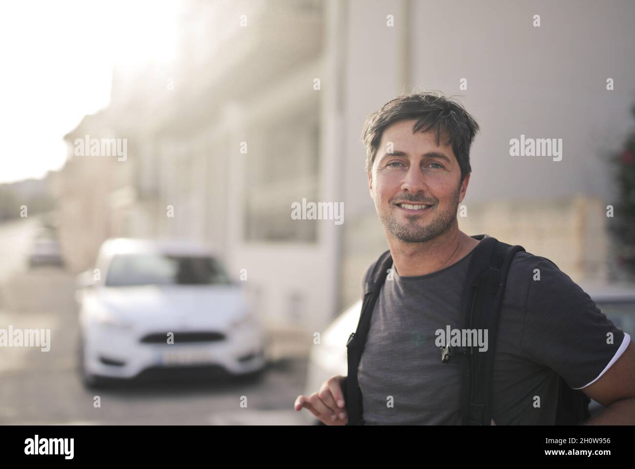 portrait of man with backpack in the street Stock Photo