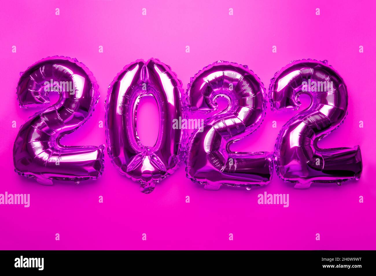 2022 Concept New Year from silver foil balloon on pink background stock photo Stock Photo