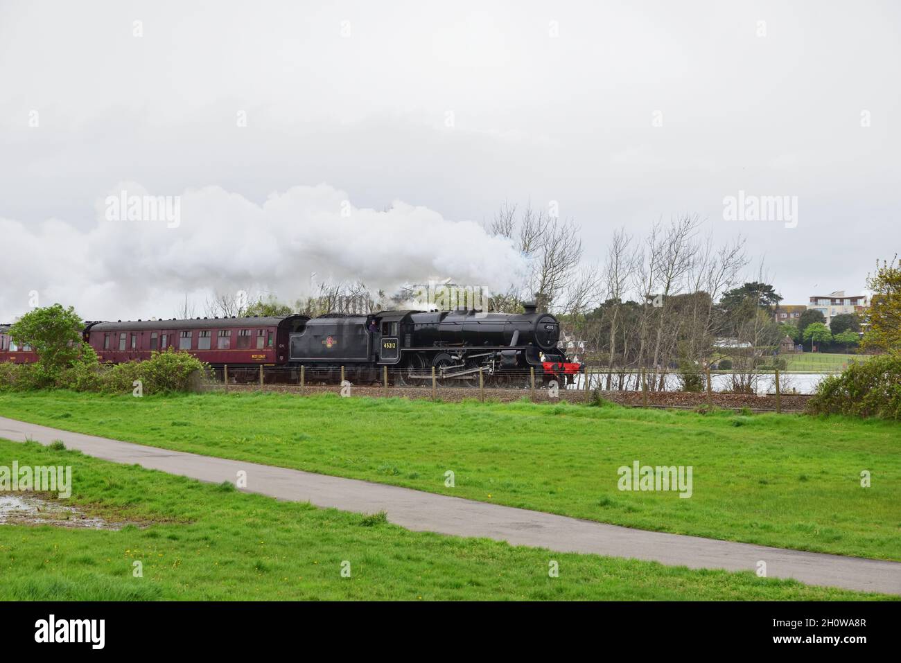 Preserved LMS Black Five 4-6-0 no. 45212 attacks the 1 in 60 Parkstone Bank with the Great Britain XI railtour, shortly after leaving Poole, Dorset Stock Photo