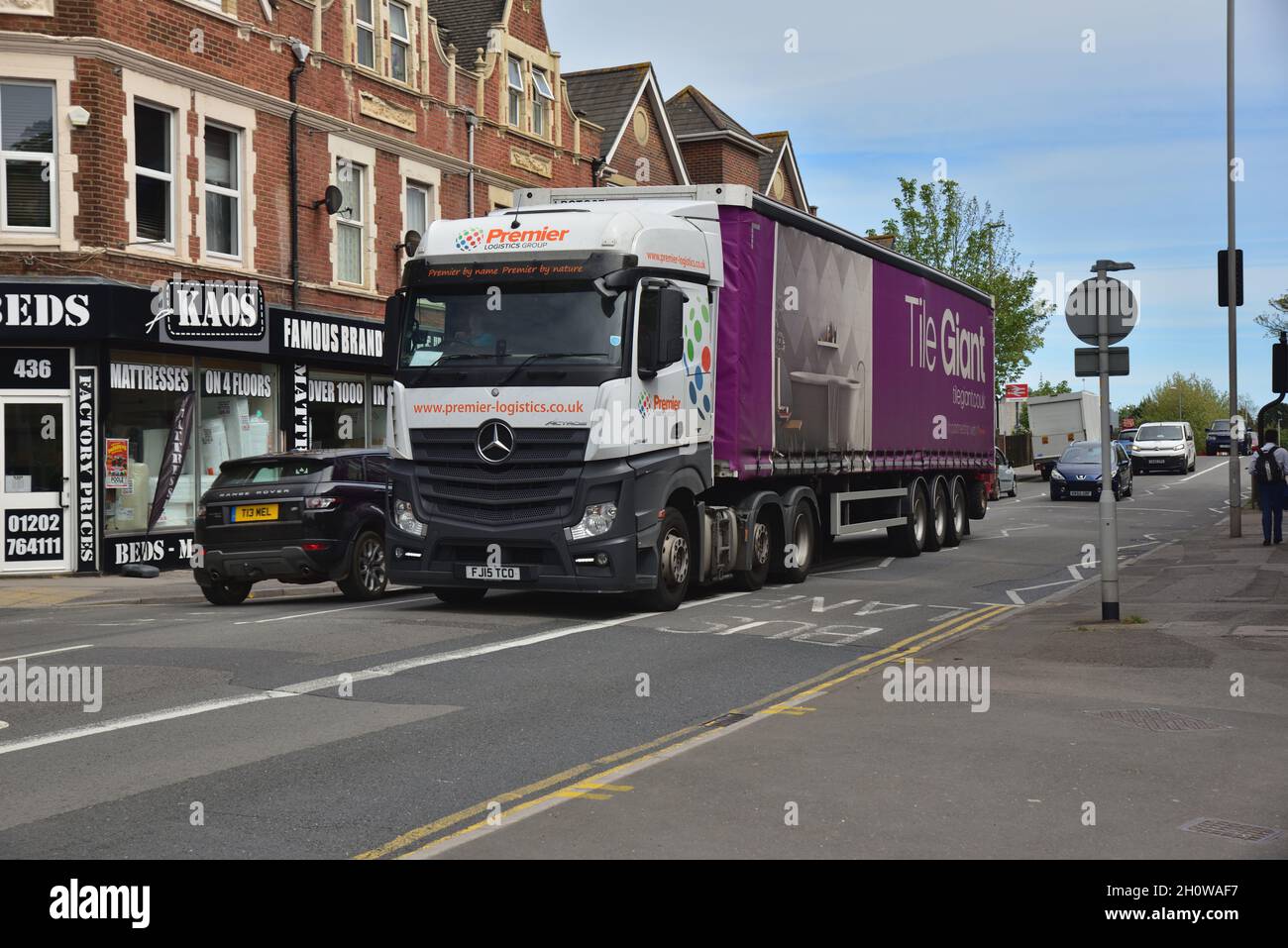 Mercedes-Benz New Actros tractor unit FJ15 TCO and trailer passing through Branksome in Poole, Dorset. The lorry is in Premier Logistics Group livery. Stock Photo