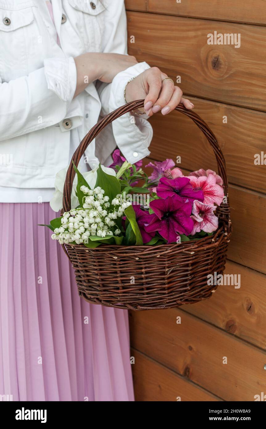 Basket with flowers and hands. Stock Photo