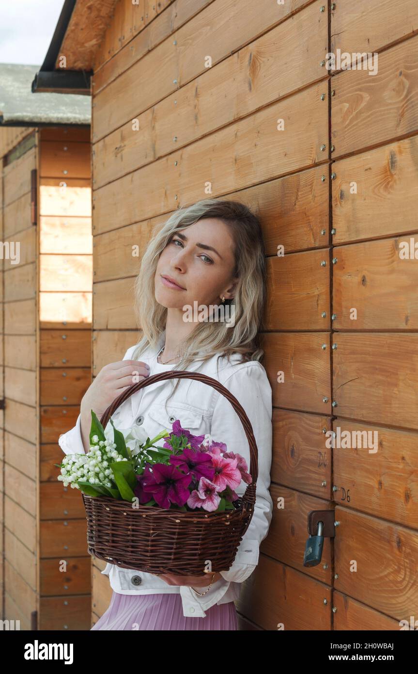 A languid girl with a basket in her hand. Stock Photo