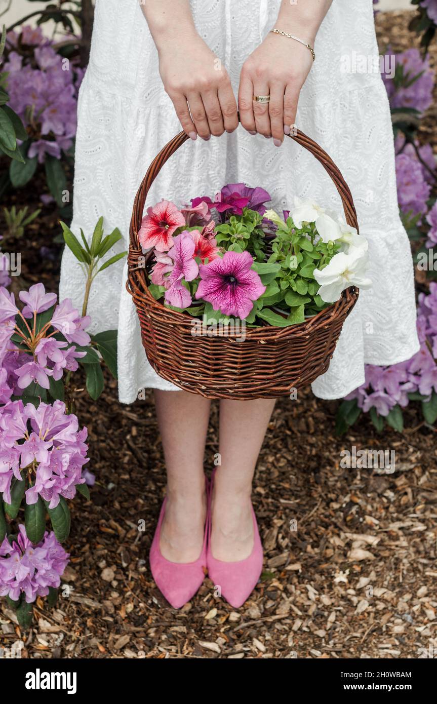 A basket of flowers and a white dress. Stock Photo