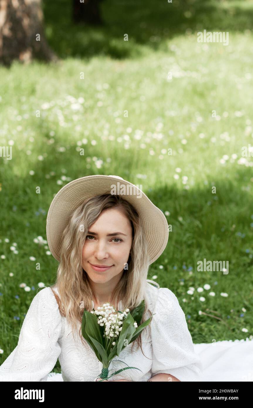 Girl with lilies of the valley. Stock Photo