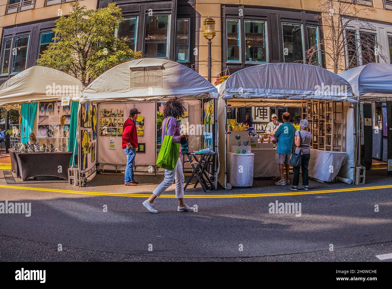 Reston, VA, USA Sept 10, 2021. A woman walks by booths set up for