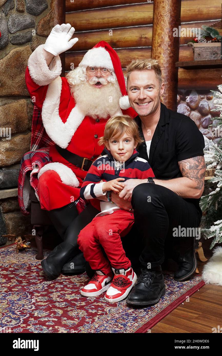Ronan Keating and his son Cooper sit in the grotto with Santa Claus as