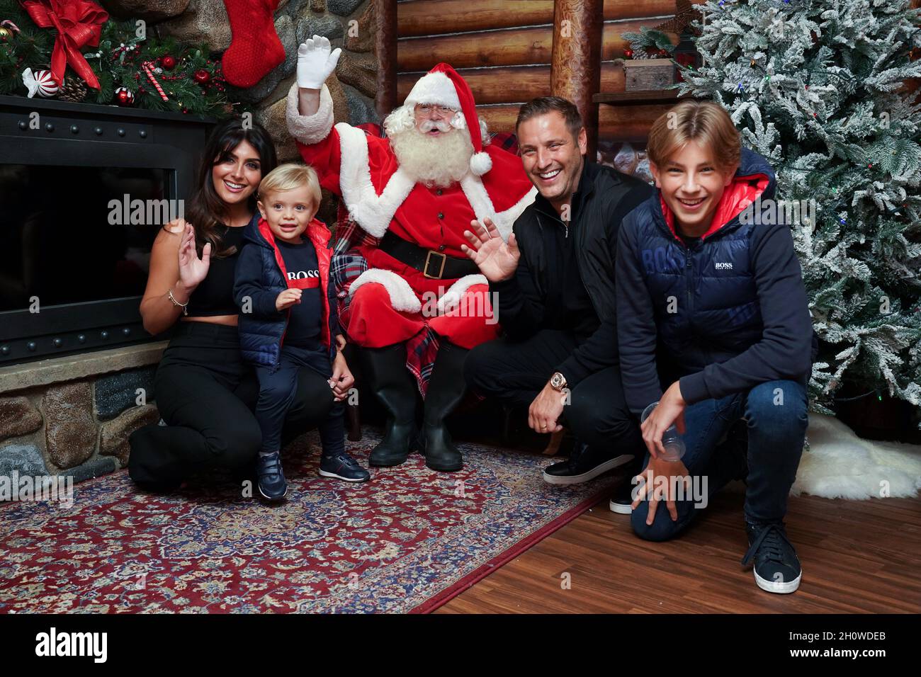 Elliot Wright, Sadie Wright and their sons Elliot (right) and Billy sit in the grotto with Santa Claus as they attend the Hamleys' Christmas Showcase 2021, in Regent Street, London. Stock Photo