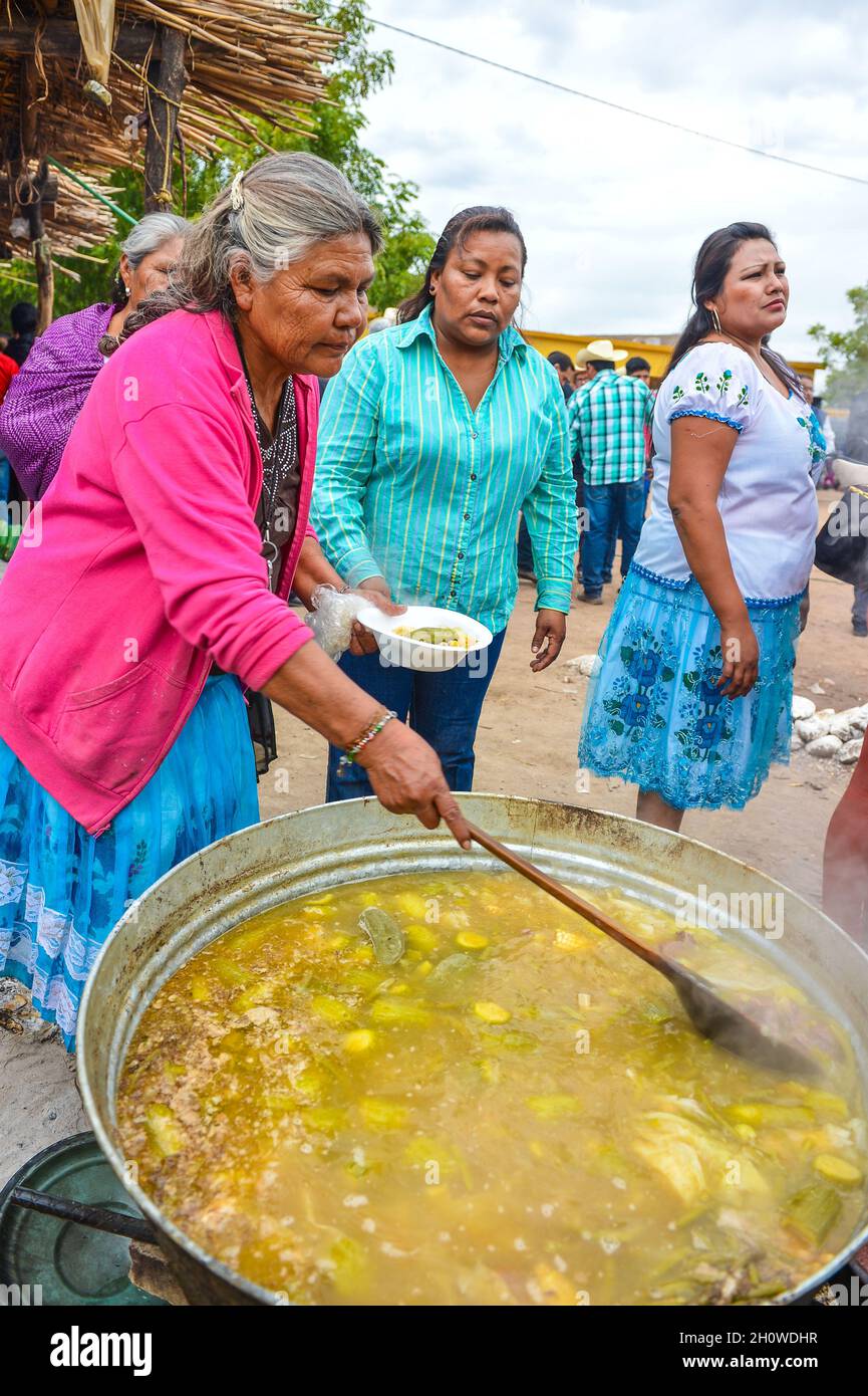 Yaqui indigenous community gathered for a traditional Wacabaque meal, meat  with chili, Cocido De Res, Gallina Pinta, recipe for beef broth cooked in a  pot. December 2021 in Vicam, Sonora, Mexico. Yaqui