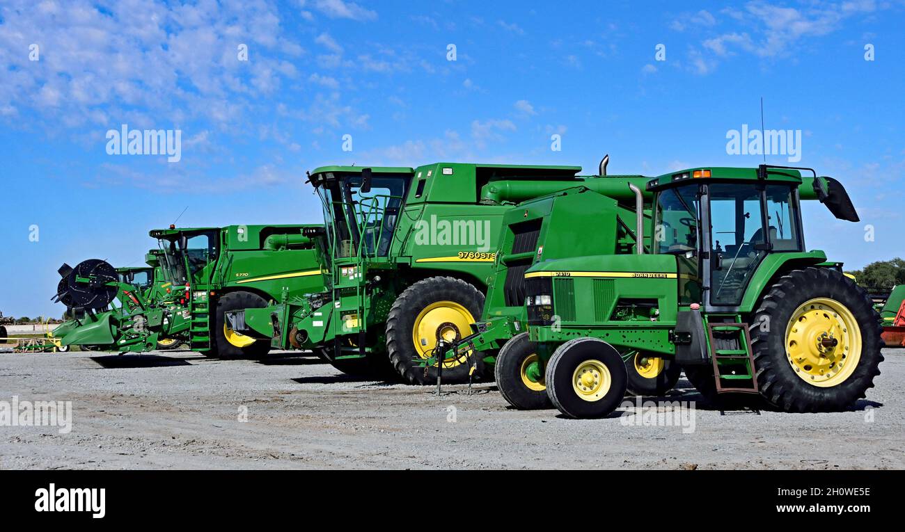 Brand new farm machinery, including tractors, combines, balers, cutter heads lined up for sale outside Prairieland Partners John Deere dealership during the first strike by John Deere workers in 35 years Stock Photo