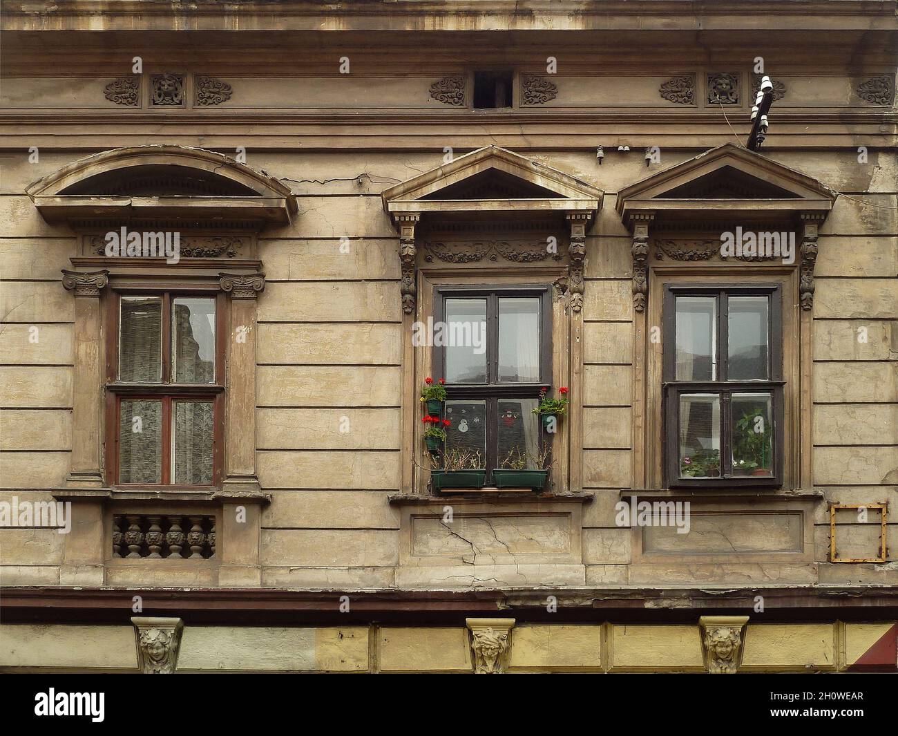 Closeup of three windows on an old house Stock Photo - Alamy