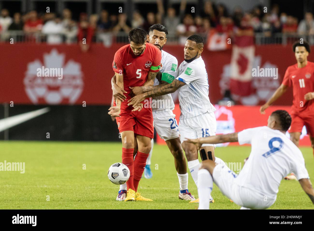 Toronto, Canada, October 13, 2021: Steven Vitória, No.5, of Team Canada is tackled by two Team Panama players, Aníbal Godoy, No.20, and Eric Davis, No.15, during the CONCACAF FIFA World Cup Qualifying 2022 match at BMO Field in Toronto, Canada. Canada won the match 4-1. Credit: Phamai Techaphan/Alamy Live News Stock Photo