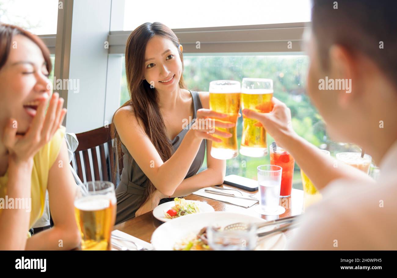 People enjoying food and drink in restaurant Stock Photo