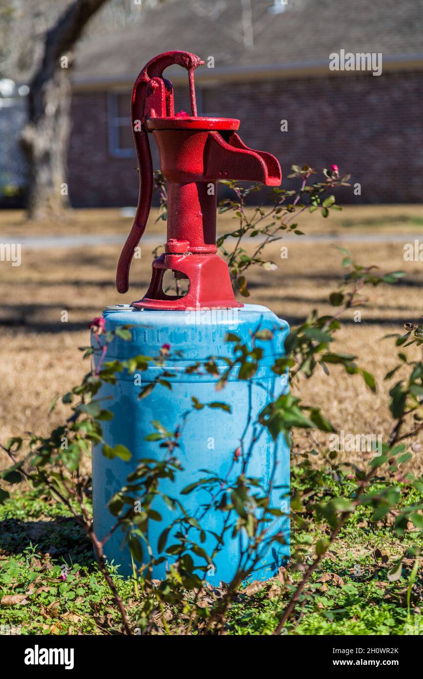 Water well pump used as a decoration in the yard of a rural residence Stock Photo
