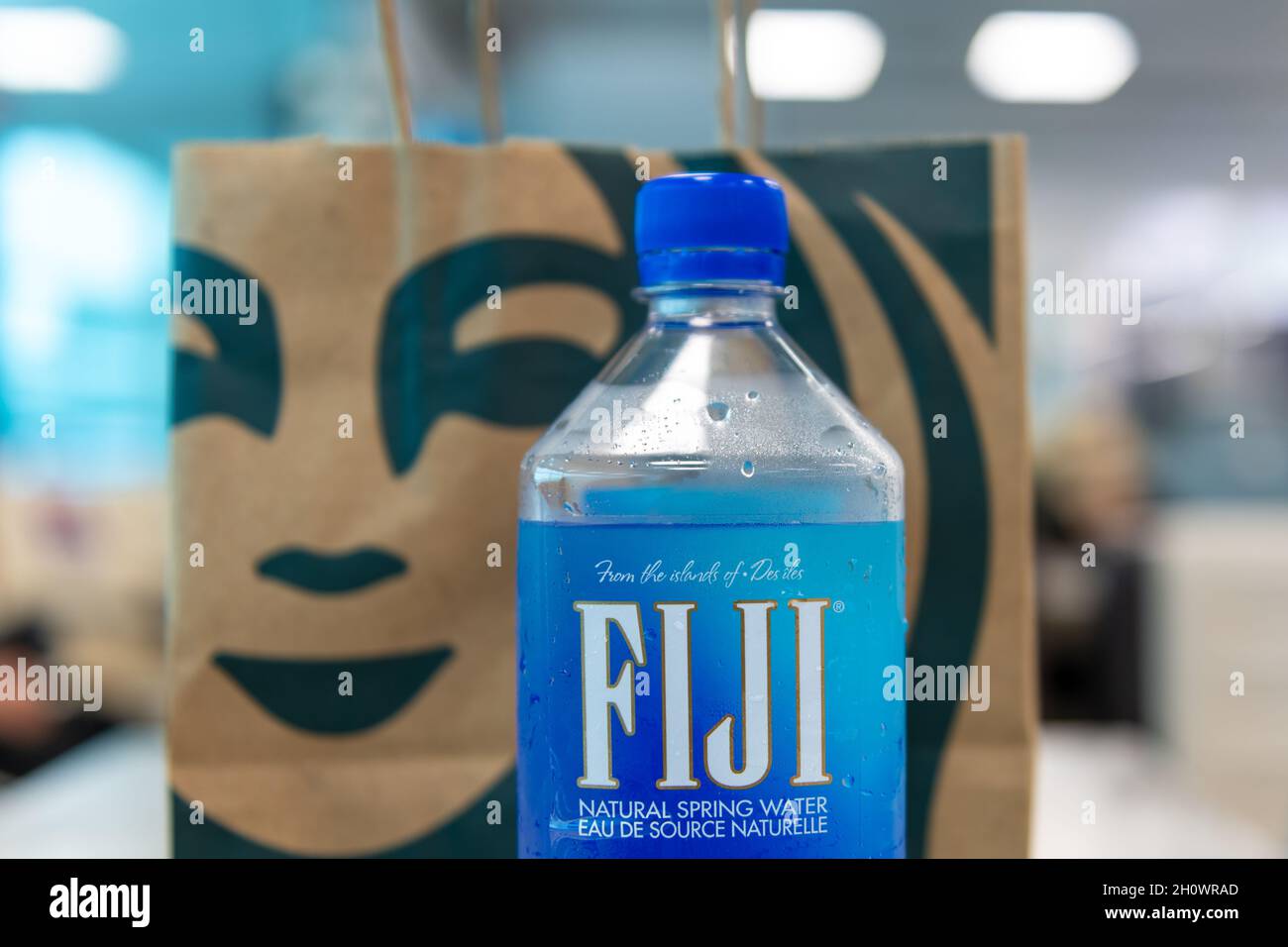 Logo of Fiji Water and Starbucks seen on a table at Pearson International Airport in Toronto city, Canada, Year 2021 Stock Photo