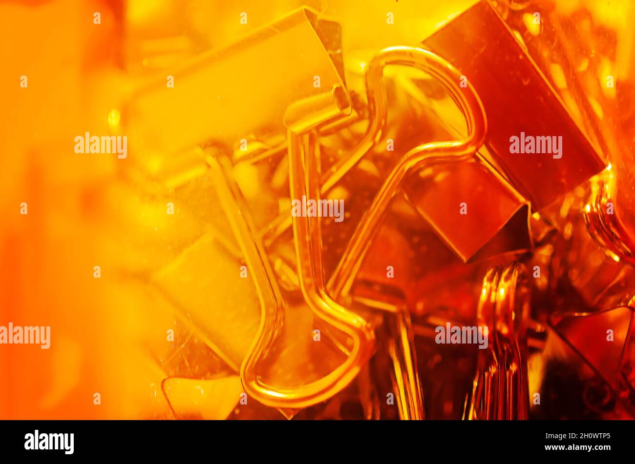 Metal binder clips, also known as foldback clips and bulldog clips, are scattered on a desk, July 20, 2016, in Coden, Alabama. Stock Photo